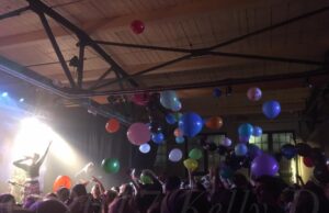 Kal Traver gesticulates amongst balloons at Gateway City Arts in Holyoke, MA - 12.30.17